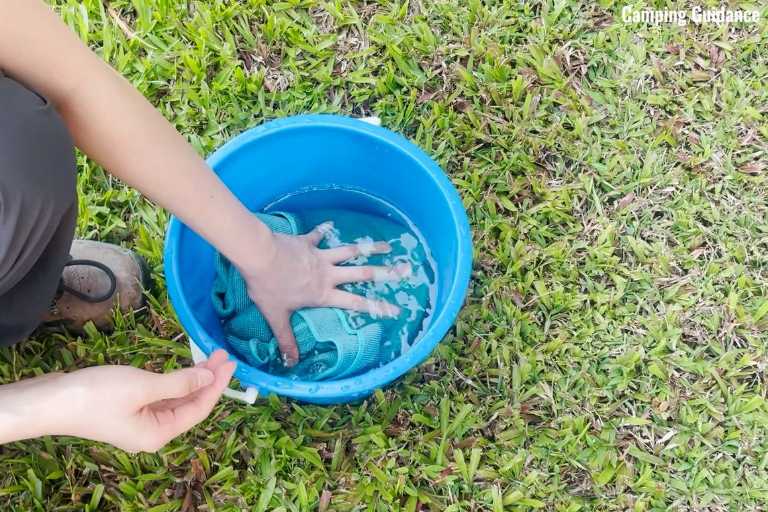 Here's a picture of me soaking the REI Multi Towel in water to test its absorbency.