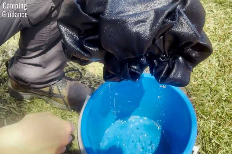 Soaking the Rainleaf Microfiber towel in a bucket to test its absorbency.