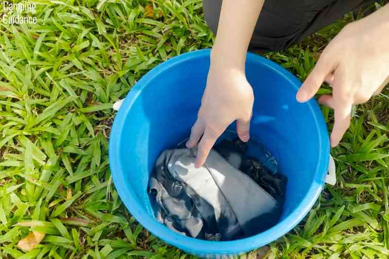 Soaking the Sea to Summit Drylite towel in a bucket to test its absorbency.