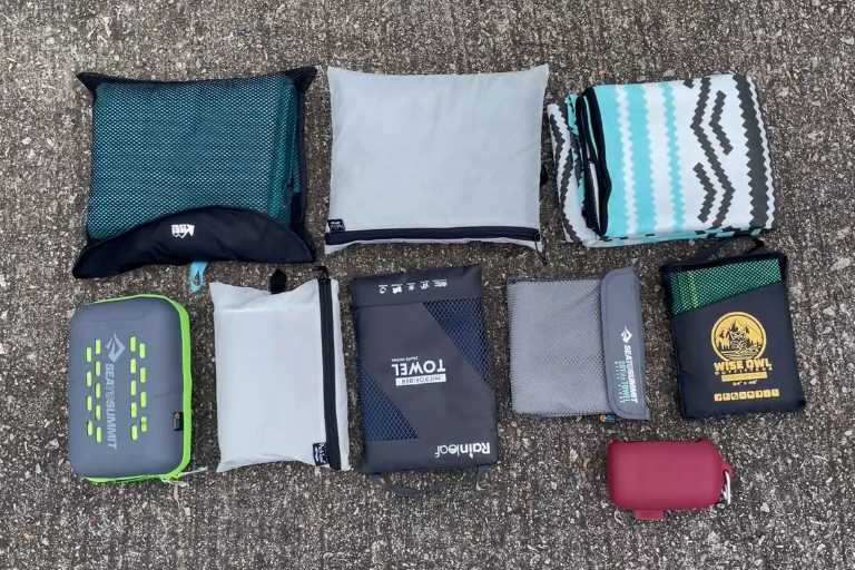 Here's what the storage pouches of 9 of the best camping towels look like. I'm missing the REI Lite's storage pouch from this shot because I forgot about it (oops). Top row from the left: REI Multi, PackTowl Luxe, Nomadix (Nomadix does not come with a storage pouch). Second row from the left: Sea to Summit Tek towel, PackTowl Personal, Rainleaf towel, Sea to Summit DryLite towel, Wise Owl Towel. The last red storage pouch belongs to the Matador NanoDry.
