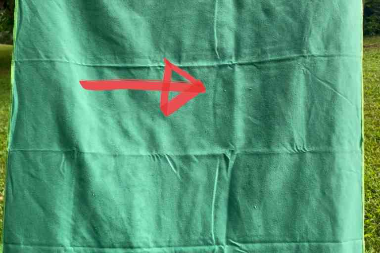 Dragging the Wise Owl Outfitters towel over some grass; it picked up a few specks of dirt.