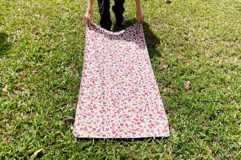 This is a picture of me testing the REI Multi Towel Lite by dragging it across some grass.