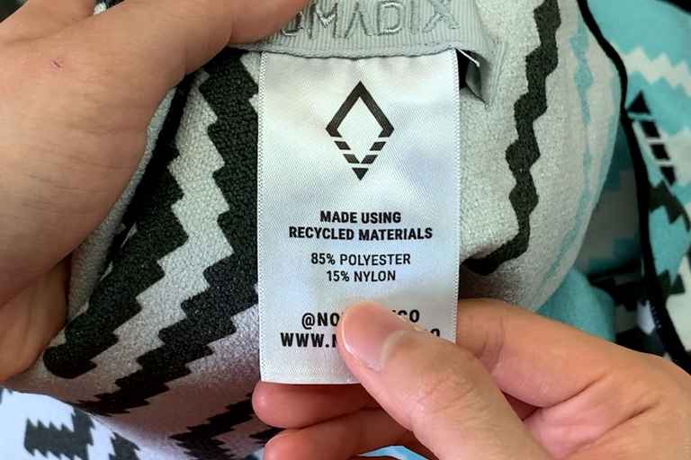 The Nomadix Original Towel product tag showing that it's made of 85% polyester and 15% nylon.