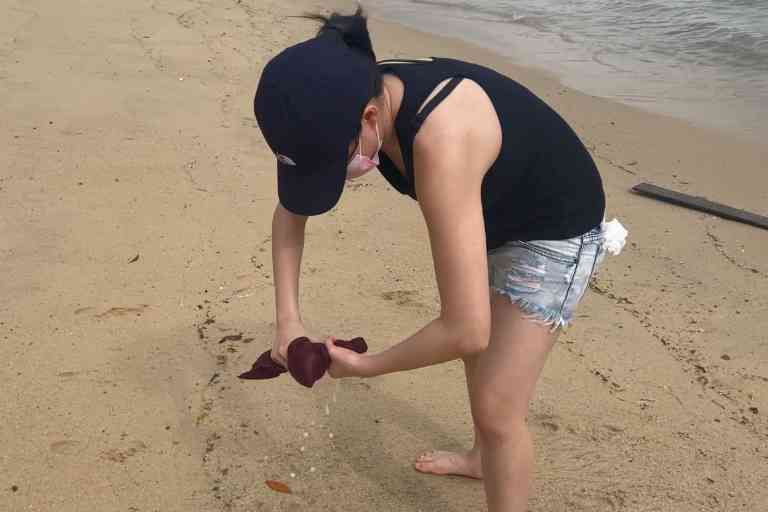 Wringing the Matador NanoDry out at a beach after soaking it in seawater.