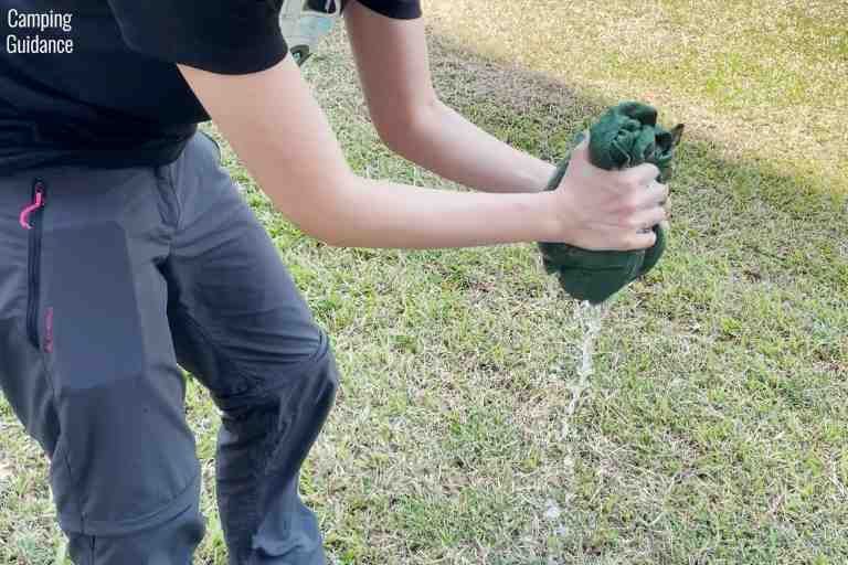Wringing out the PackTowl Luxe to see how much water would be left.