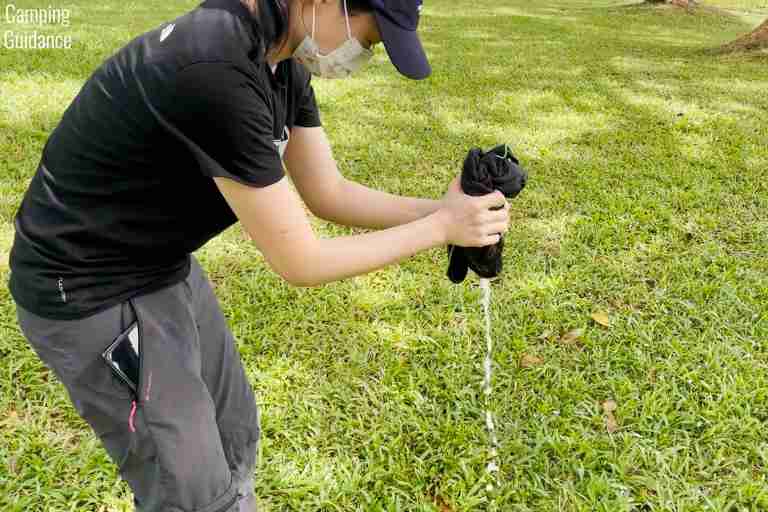 Wringing out the PackTowl Personal to see how much water would be left.