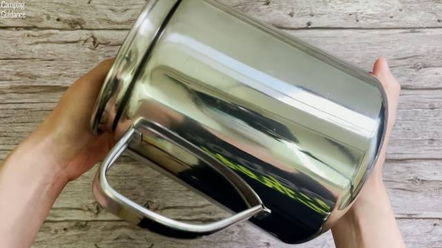 The coffee pot and handle of the Coleman 12-Cup Stainless Steel Percolator.