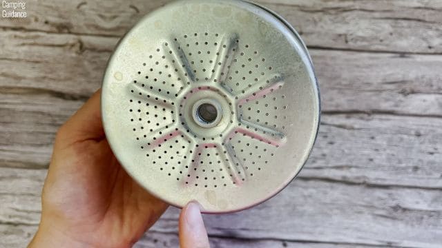 Coffee stains on the filter basket of the Primula Today Aluminum 9-Cup Percolator.