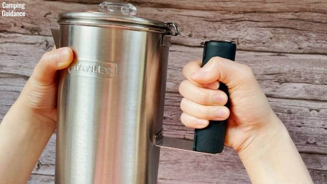 Me holding onto the removable silicone handle on the Stanley Camp Percolator.
