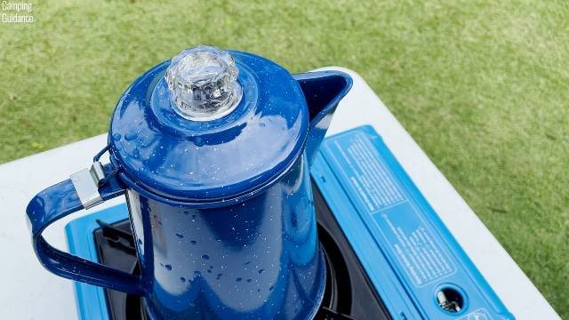 Brewing coffee outdoors in the GSI Outdoors 8-Cup Enamelware Percolator on a Coleman Portable Butane Stove.