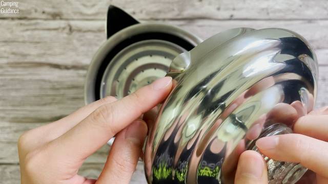 The notch in the lid of the Coleman 12-Cup Stainless Steel Percolator.