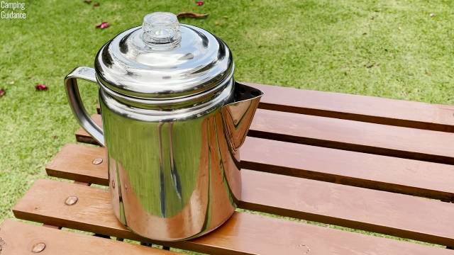 I placed the Coleman 12-Cup Stainless Steel Percolator on a table outdoors.