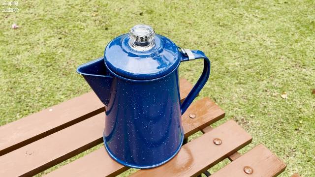 I placed the GSI Outdoors Enamelware 8-Cup Percolator on a table outdoors.