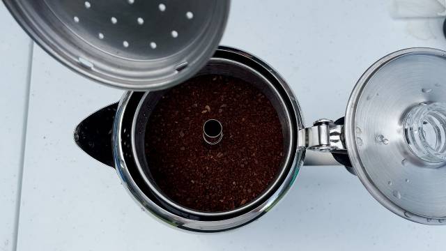 Putting the spreader on top of the stem/tube and filter basket of the GSI Outdoors Glacier 3-Cup Percolator.