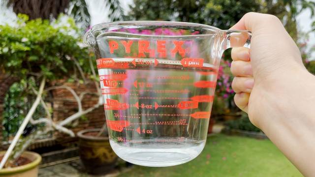 Using a Pyrex measuring cup to measure out 6 ounces of water for 1 cup of coffee.