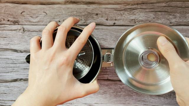 The lid of the Stanley Camp Percolator is hinged to the coffee pot.