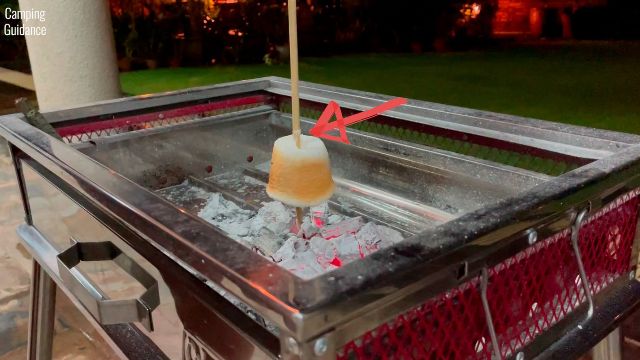 Here's a photo of me roasting a marshmallow with the bamboo marshmallow roasting stick and hanging it downwards.