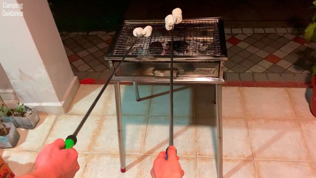 Here's 2 Sumpri Marshmallow Roasting Sticks being used to roast marshmallows.