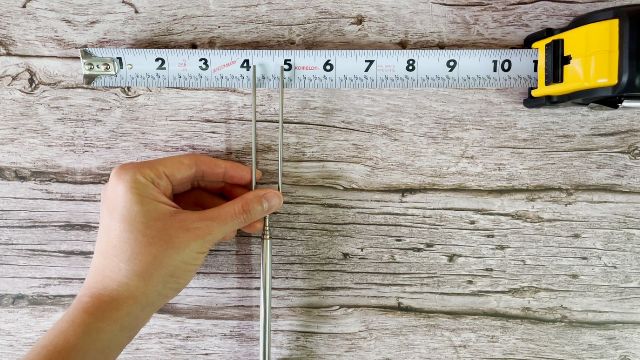 This is a picture of me measuring the distance between the tines of the MalloMe Marshmallow Roasting Sticks, which is about 0.75 inches or 1.9 cm.