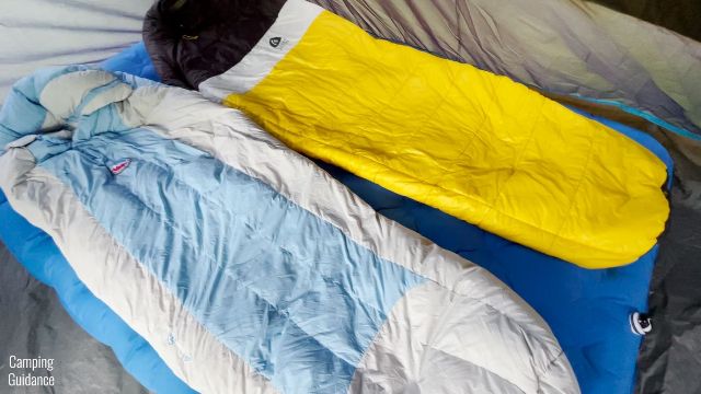 This picture shows 2 sleeping bags on top of the Sierra Designs 2-Person Camping Air Mattress.