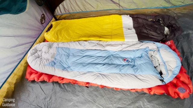 This is a picture of 2 sleeping bags on top of a Klymit Double V Insulated Sleeping Pad.