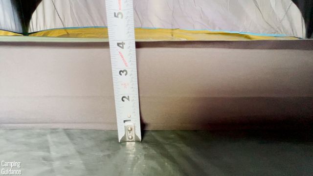 This is a picture of me measuring the thickness of the Exped MegaMat Duo 10 (4 inches).