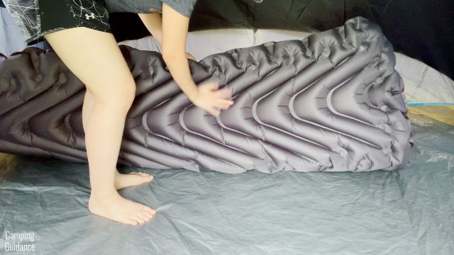 This is a picture of me touching the bottom surface of the Klymit Double V Insulated Sleeping Pad.