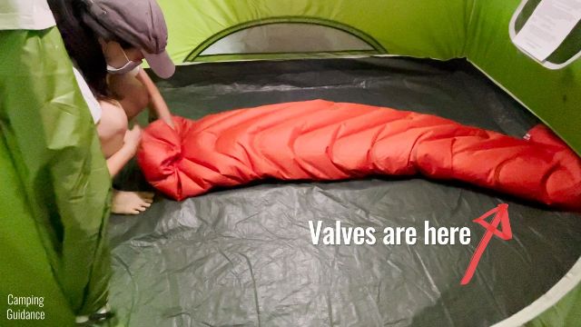 This is a picture of me deflating the Klymit Double V Insulated Sleeping Pad by rolling it up.