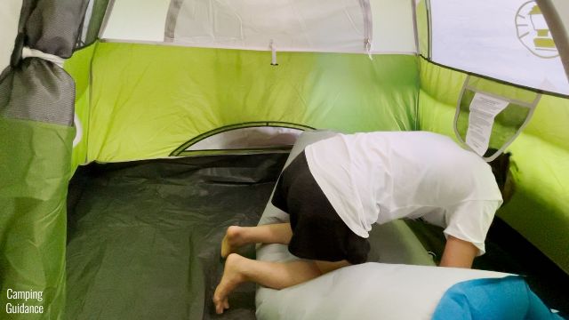 This is a picture of me using my body weight to deflate the Sierra Designs 2-Person Camping Air Mattress.