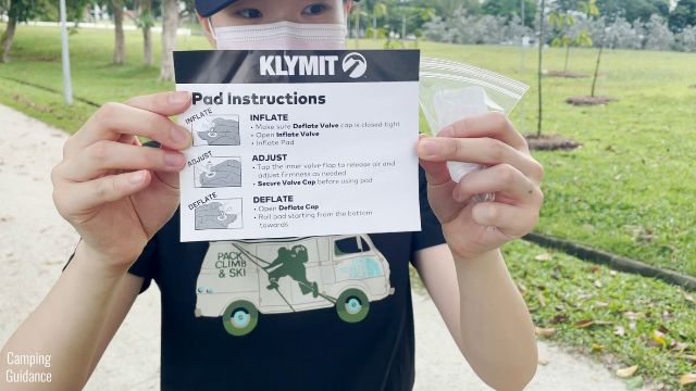 This is a picture of me holding up the instructions and patch kit that came with the Klymit Double V Insulated.