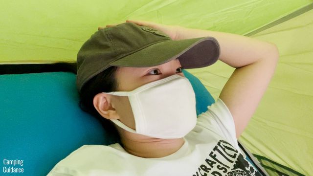 This picture shows the tent walls of the Coleman 2-Person Sundome Tent brushing against my head while lying down on the Sierra Designs 2-Person Camping Air Mattress.