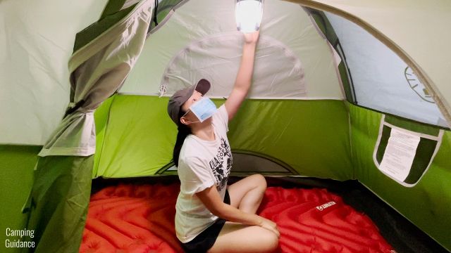 This is a picture of me sitting on the Klymit Double V Insulated Sleeping Pad inside a Coleman 2-Person Sundome Tent.