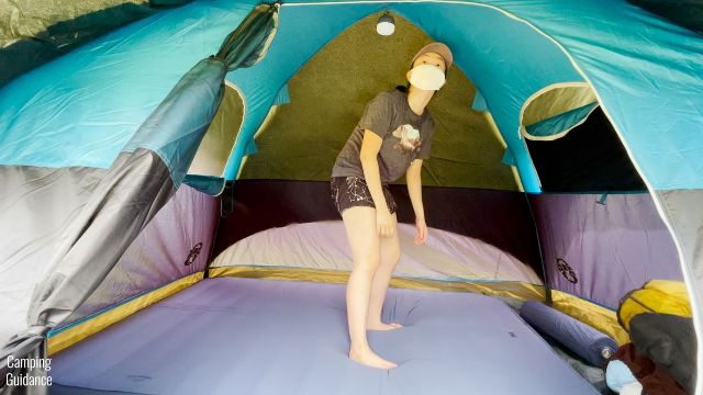 This is a picture of me standing up on the REI Camp Dreamer Double inside a Coleman 4-Person Dome Tent.