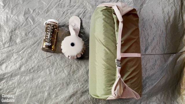 This is a picture of my Exped MegaMat Duo 10 back in its stuff sack, beside the mini-pump and a 32-ounce Nalgene bottle for a size comparison.