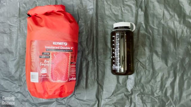 Here's what the Klymit Double V Insulated Sleeping Pad (packed up) looks like beside a 32-ounce Nalgene bottle for a size comparison.
