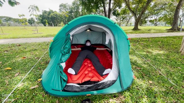 This is a picture of me lying down on the Klymit Double V Insulated Sleeping Pad inside a Quechua 2 Seconds Pop Up Tent. 