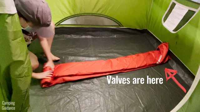 This is a picture of me rolling the Klymit Double V Insulated Sleeping Pad to pack back into the stuff sack.