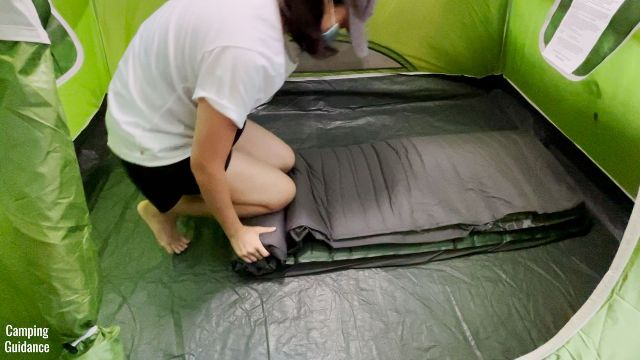This is a picture of me using my knees, hands and body weight to roll up the Exped MegaMat Duo 10.