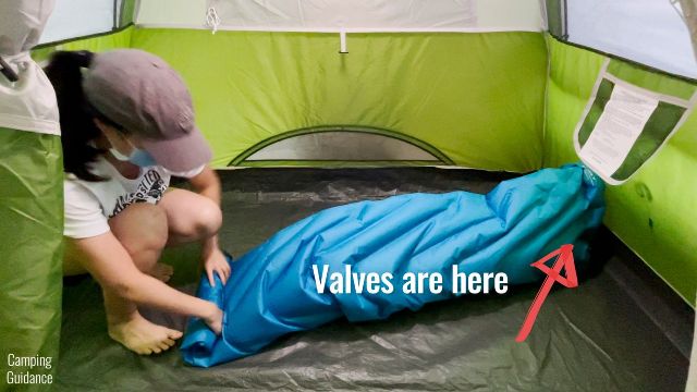 This is a picture of me deflating and rolling up the Klymit Double V Uninsulated Sleeping Pad.