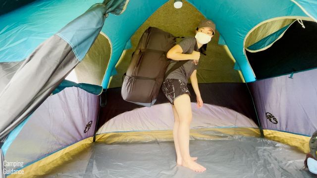 This is a picture of me using the shoulder strap of the REI Camp Dreamer Double to carry it around.