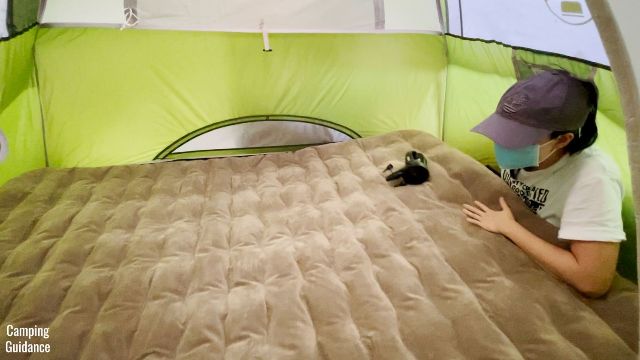 This is a picture of me trying to inflate the Etekcity Upgraded Camping Air Mattress while inside the Coleman 2-Person Sundome Tent.