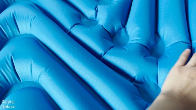 This is a picture of me touching the V shaped air chambers of the Klymit Double V Uninsulated Sleeping Pad.
