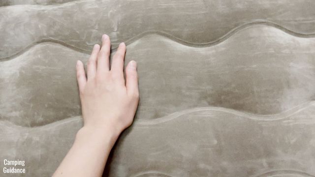 This is a picture of me running my hand over the baffling of the Etekcity Upgraded Camping Air Mattress.
