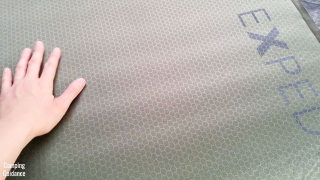 This is a picture of me running my hand over the surface of the Exped MegaMat Duo 10.