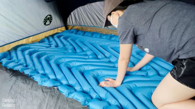 This is a picture of me touching the top surface of the Klymit Double V Uninsulated Sleeping Pad.
