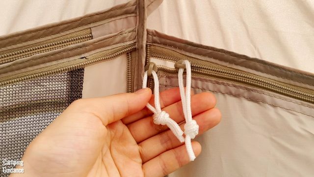 This is a picture of me holding 2 window zippers of the Coleman WeatherMaster 10-Person Tent.