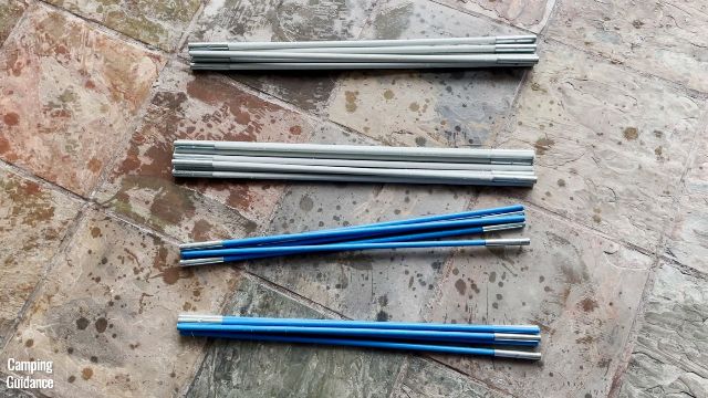 This is a picture of the 4 fiberglass poles for the roof of the Columbia Mammoth Creek 10-Person Tent. 2 are white (top), and 2 are blue (bottom).