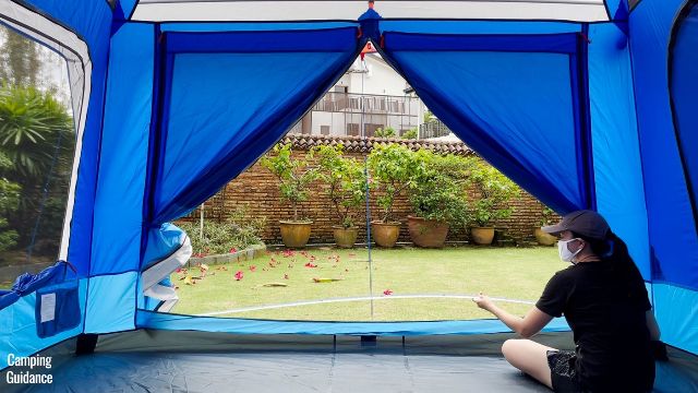 This is a picture of me using a tape measure to measure the dimensions of the T-door of the Columbia Mammoth Creek 10-Person Tent (91 by 55 inches).