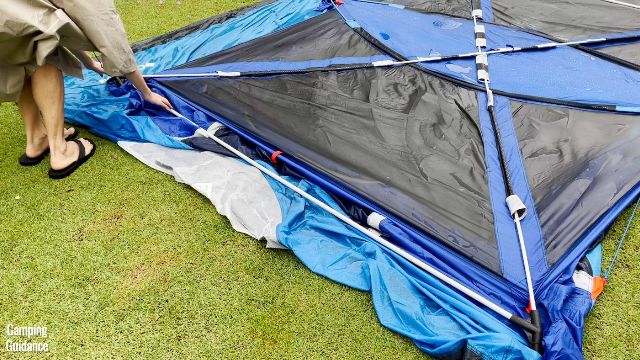 This is a picture of me attaching the 2 additional steel poles to the roof of the Columbia Mammoth Creek 10-Person Tent.