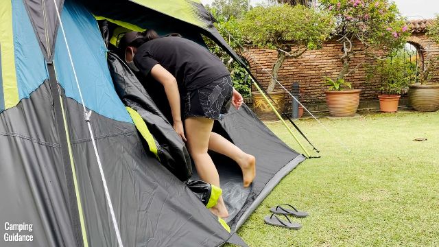 This is a picture of me ducking to get through the back door of the Coleman 10-Person Instant Cabin Tent.